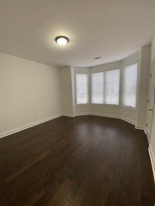 spare room featuring dark hardwood / wood-style floors