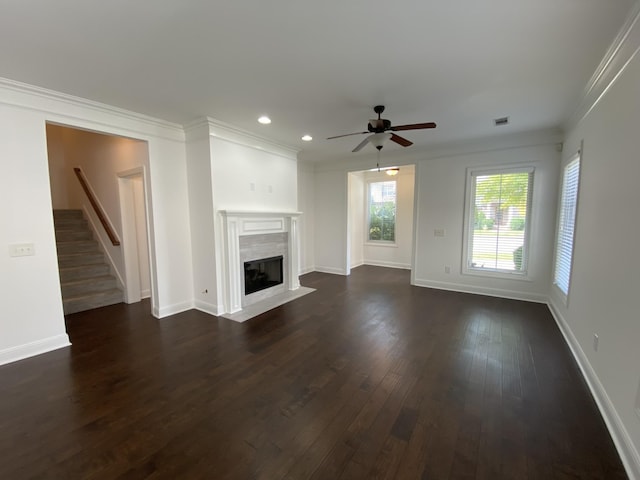 unfurnished living room featuring ceiling fan, crown molding, and dark hardwood / wood-style floors