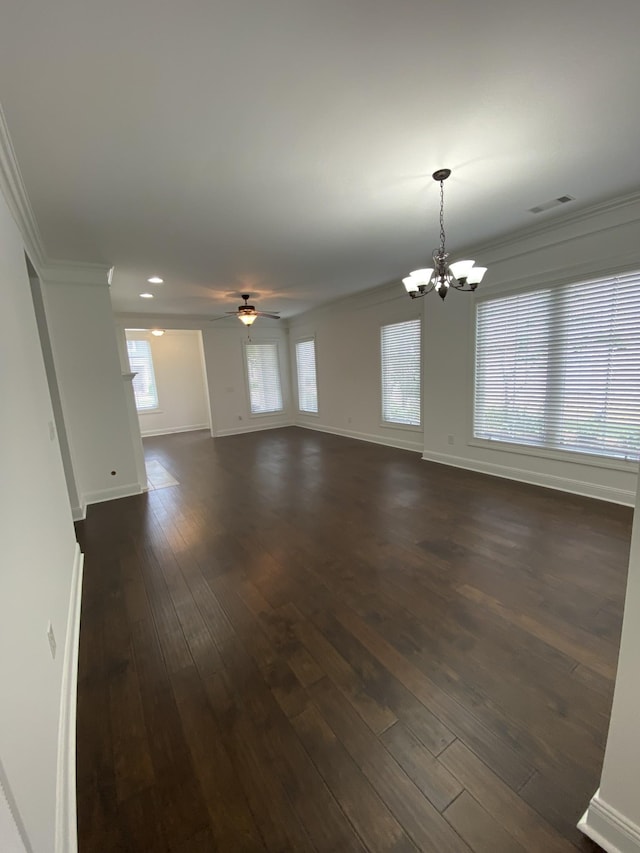 interior space featuring dark hardwood / wood-style floors, crown molding, and ceiling fan with notable chandelier