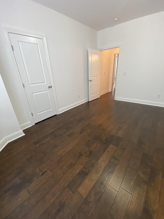 empty room featuring dark wood-type flooring