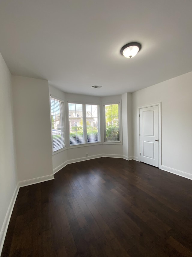 spare room featuring dark hardwood / wood-style floors