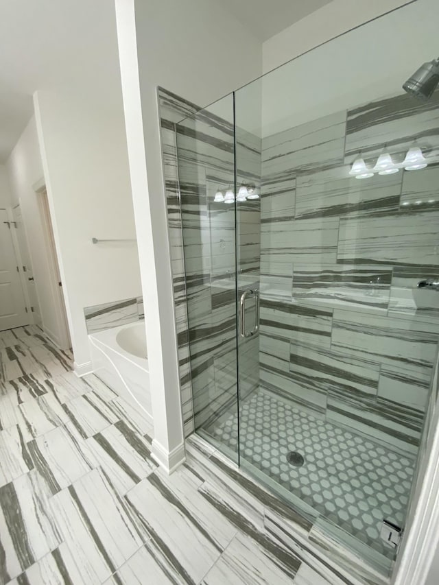 bathroom with separate shower and tub