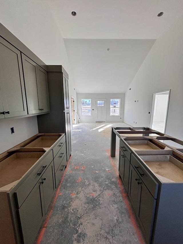 kitchen featuring gray cabinetry and high vaulted ceiling