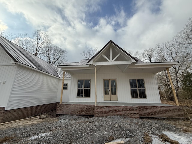 rear view of house featuring french doors