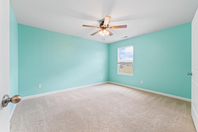 carpeted spare room featuring ceiling fan