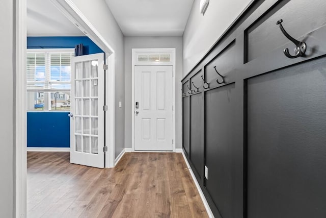 entryway with hardwood / wood-style floors