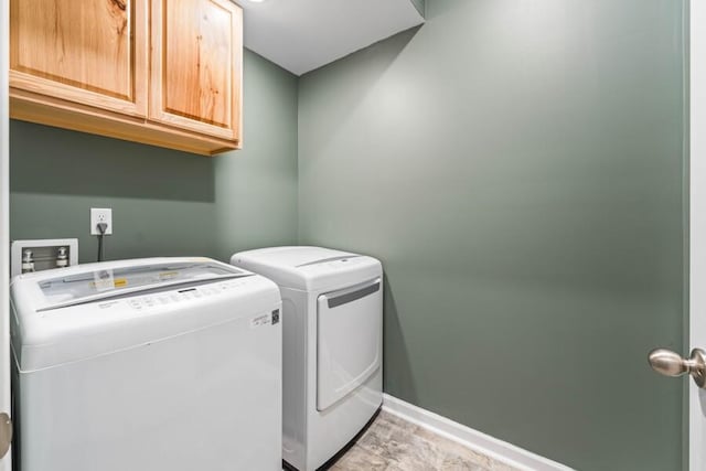 washroom with cabinets and washer and clothes dryer