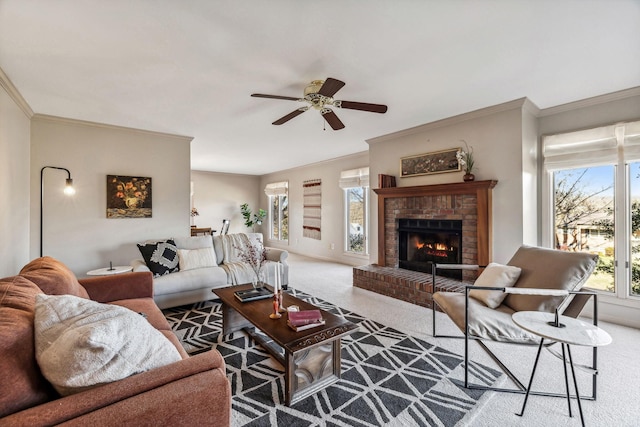 carpeted living room with ceiling fan, ornamental molding, and a brick fireplace