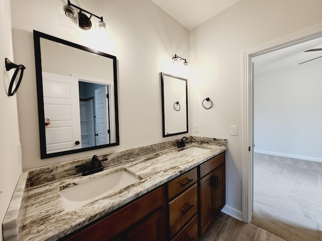 bathroom with vanity, hardwood / wood-style flooring, and ceiling fan