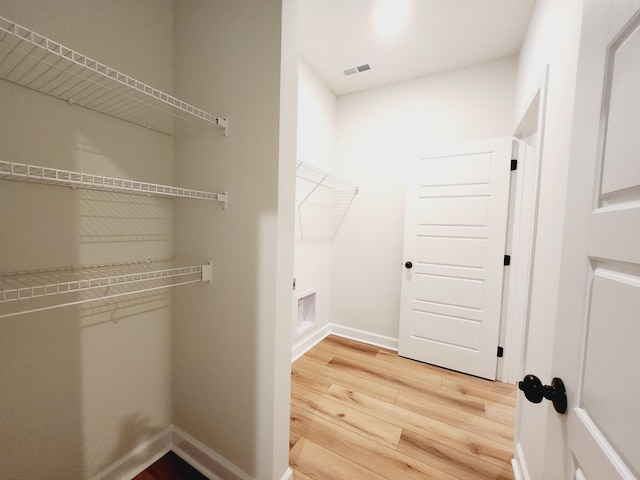 spacious closet with hardwood / wood-style floors