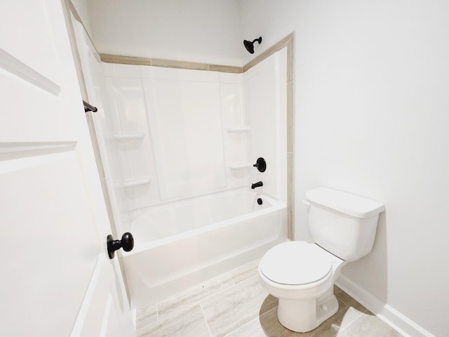 bathroom with shower / bathing tub combination and toilet