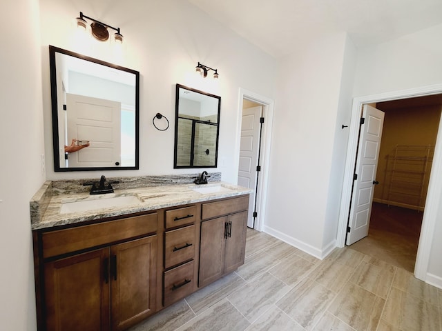 bathroom featuring vanity and a shower with shower door