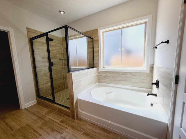 bathroom featuring separate shower and tub