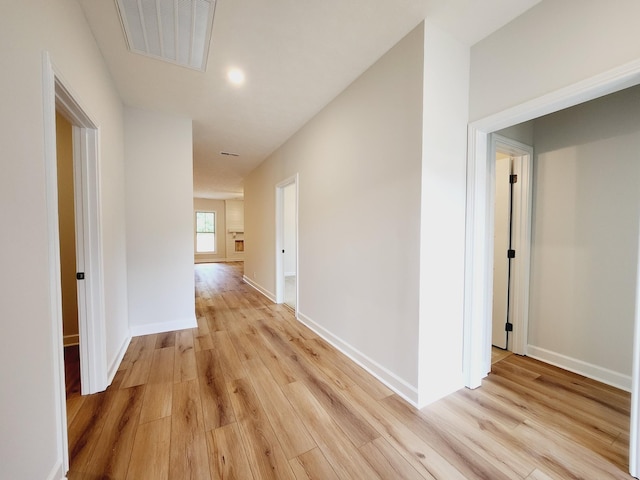 corridor with light hardwood / wood-style flooring