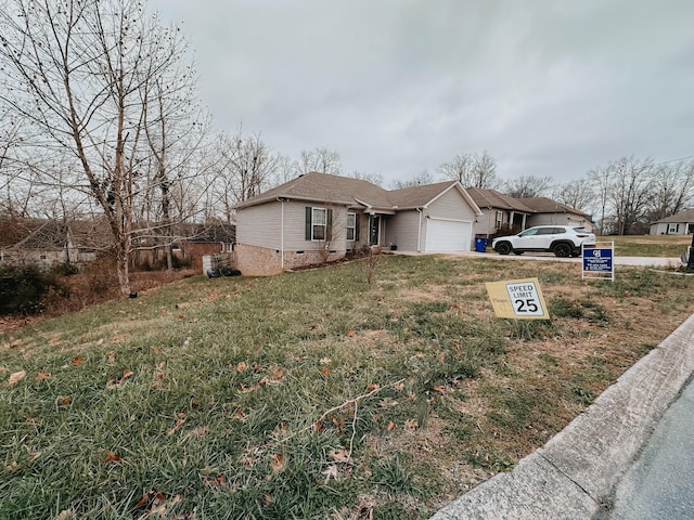 single story home featuring a garage and a front lawn