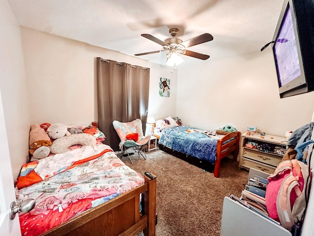 carpeted bedroom featuring a textured ceiling and ceiling fan