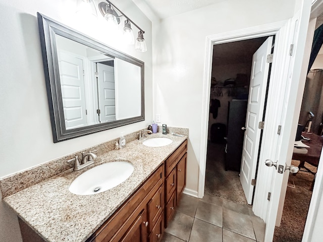 bathroom featuring tile patterned flooring and vanity