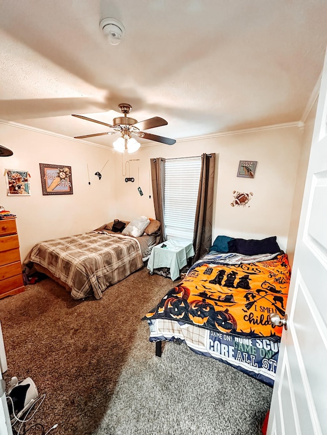 bedroom featuring carpet floors, ceiling fan, and crown molding