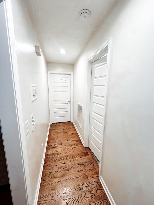 corridor featuring light hardwood / wood-style floors