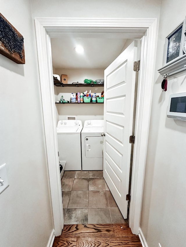 laundry room with washer and clothes dryer and light tile patterned floors