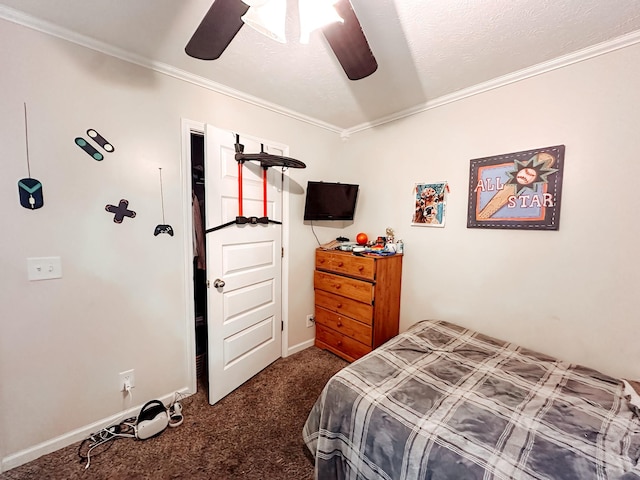 bedroom featuring dark colored carpet, ceiling fan, ornamental molding, and a textured ceiling