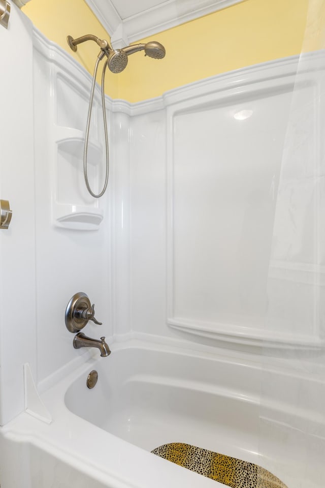 bathroom with tub / shower combination and ornamental molding