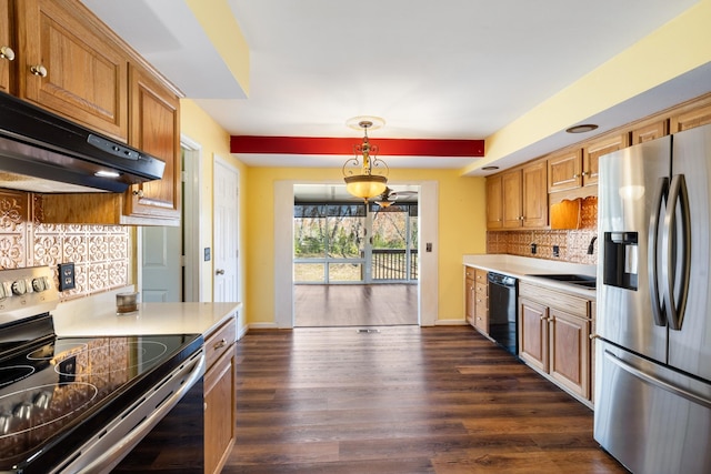 kitchen featuring backsplash, sink, dark hardwood / wood-style floors, stainless steel appliances, and extractor fan