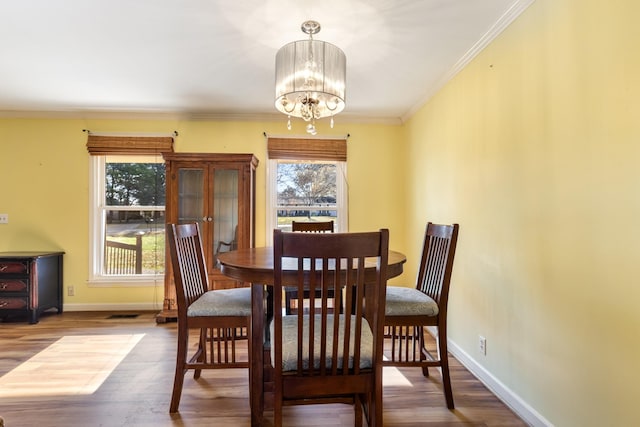 dining room featuring crown molding, a chandelier, and wood-type flooring