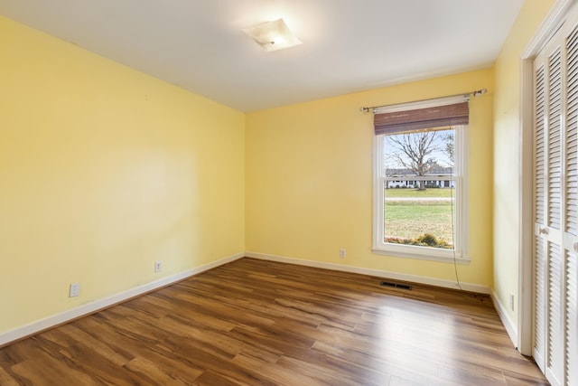 unfurnished room with wood-type flooring