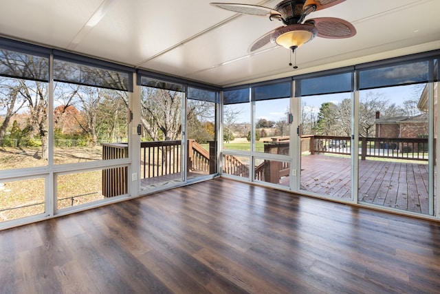 unfurnished sunroom featuring ceiling fan