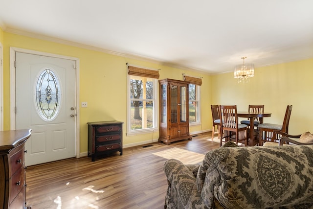 interior space with crown molding, dark hardwood / wood-style floors, and a notable chandelier