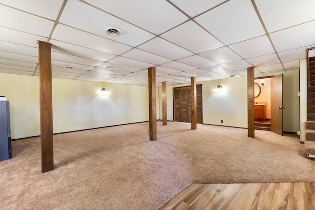 basement with carpet flooring and a paneled ceiling