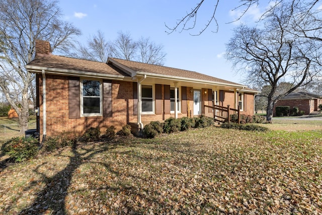 ranch-style house with a front yard and a porch