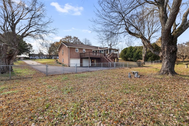 view of yard featuring a wooden deck and a garage