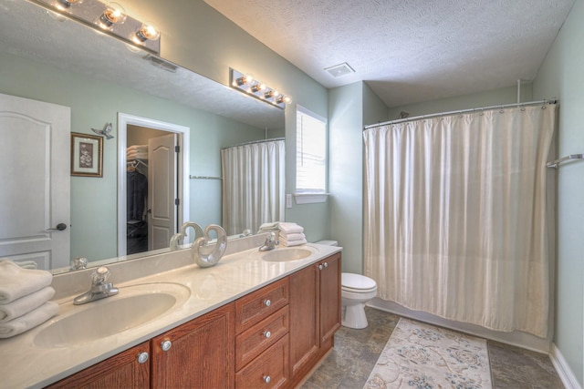 full bathroom featuring vanity, shower / bath combo, toilet, and a textured ceiling