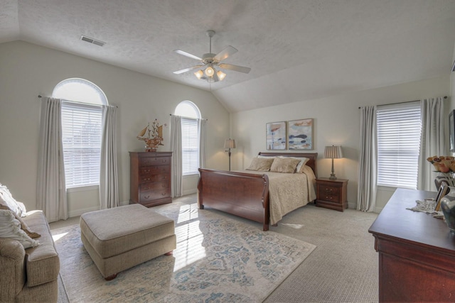 bedroom featuring vaulted ceiling, multiple windows, and ceiling fan