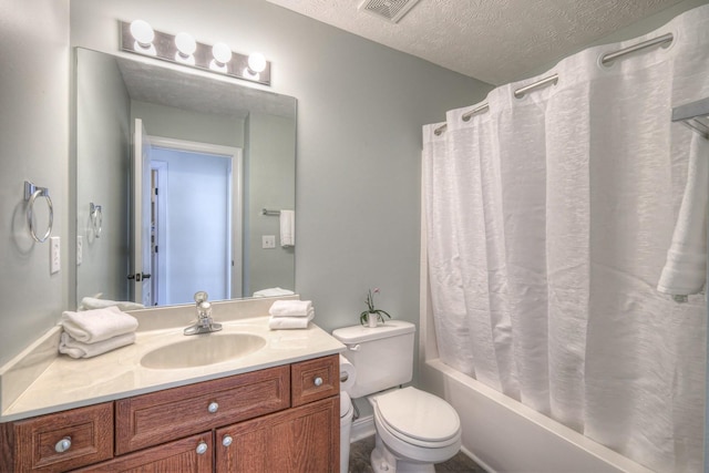 full bathroom featuring vanity, shower / bath combo, toilet, and a textured ceiling