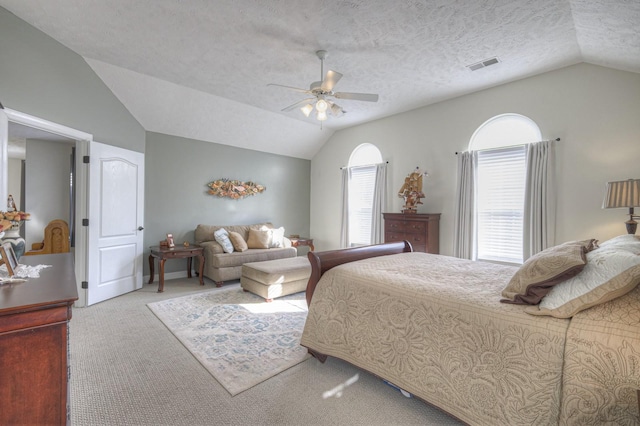 carpeted bedroom featuring a textured ceiling, ceiling fan, and vaulted ceiling