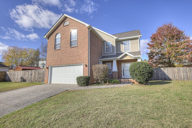 view of property with a garage and a front yard