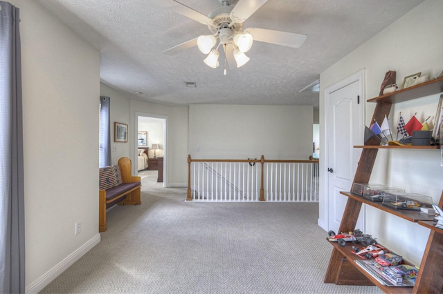 interior space featuring a textured ceiling and light colored carpet