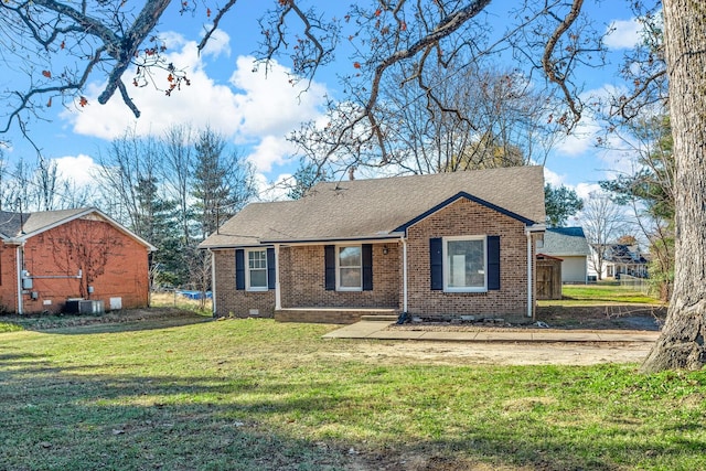 view of front of home with central air condition unit and a front lawn