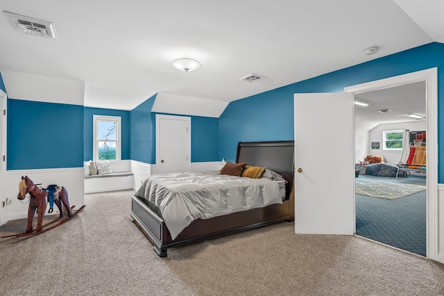 bedroom featuring carpet flooring and lofted ceiling