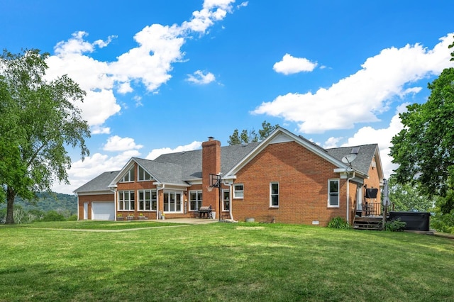 back of house featuring a yard, a deck, and a garage