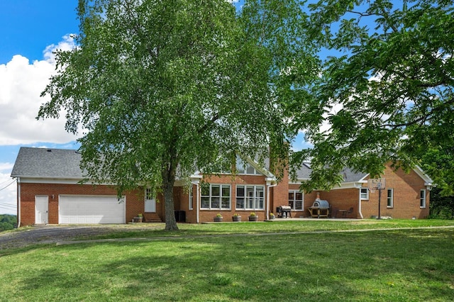 ranch-style home featuring a garage and a front lawn