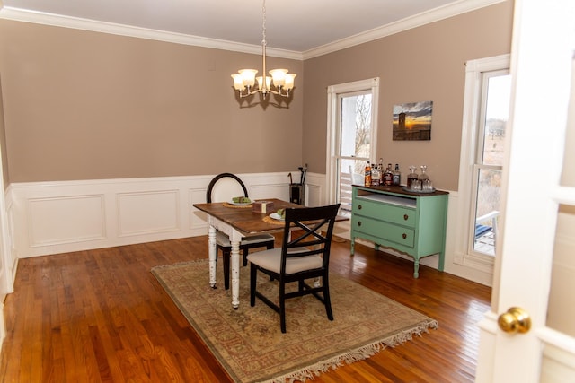 dining space with an inviting chandelier, dark hardwood / wood-style floors, and ornamental molding