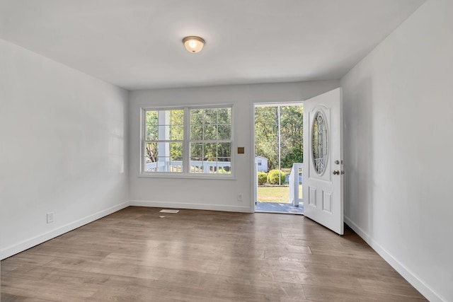 entrance foyer featuring wood finished floors, visible vents, and baseboards