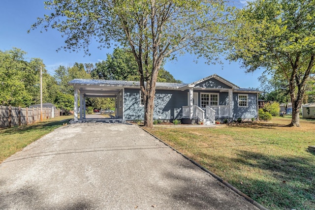 single story home featuring covered porch, a front yard, and a carport