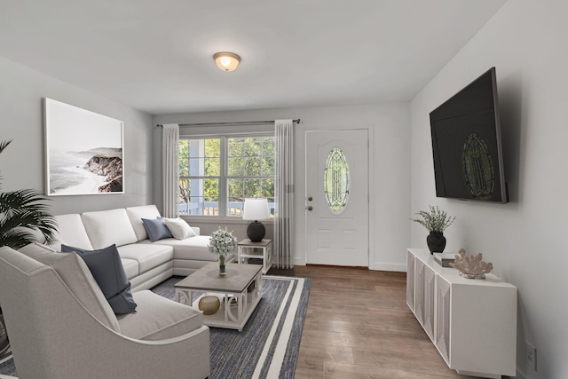 living area featuring baseboards and wood finished floors