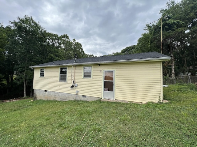 rear view of property with a yard