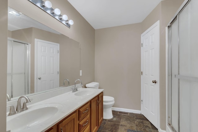 bathroom with vanity, an enclosed shower, and toilet